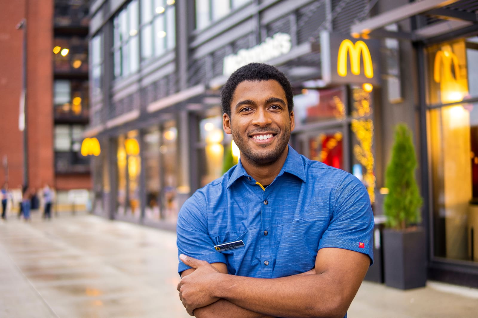 An Arch Fellow restaurant manager outside his restaurant